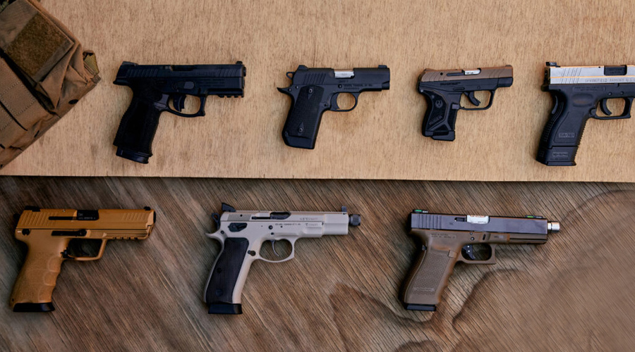 A table with several different types of guns